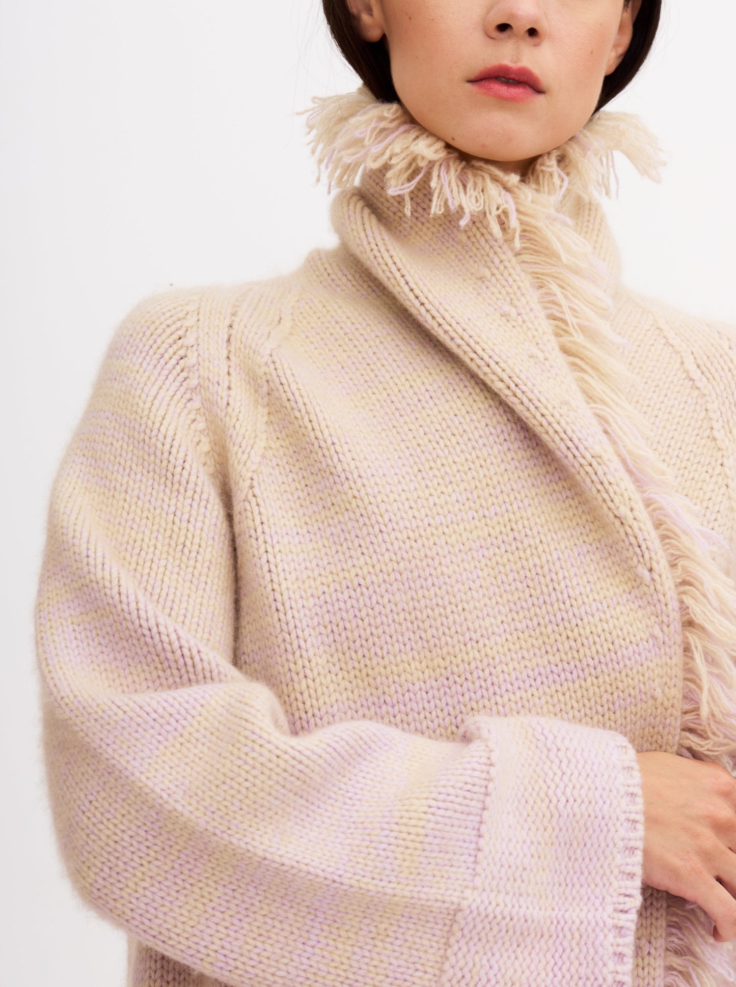 Light pink cashmere robe coat with fringe detailing, worn with matching pink knitted pants