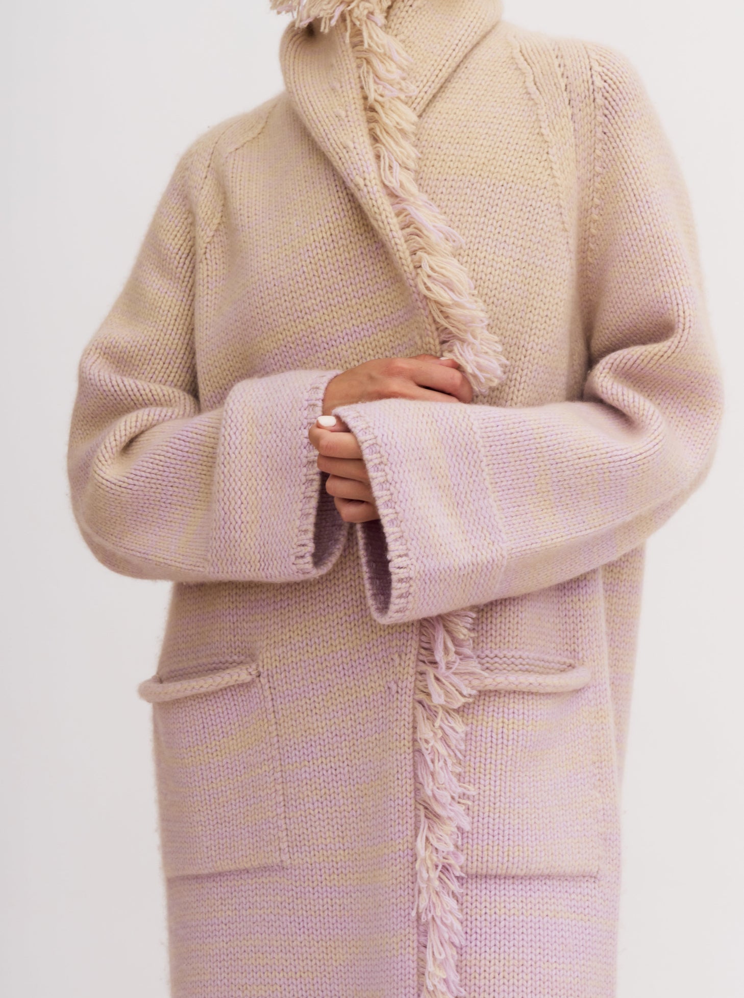 Light pink cashmere robe coat with fringe detailing, worn with matching pink knitted pants