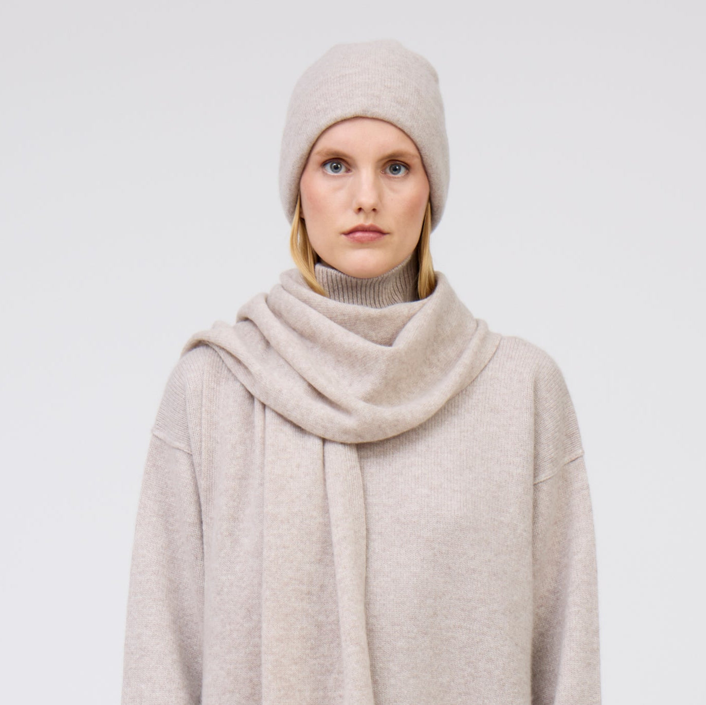 Modal wears pale beige cashmere beanie hat and matching scarf and jumper.