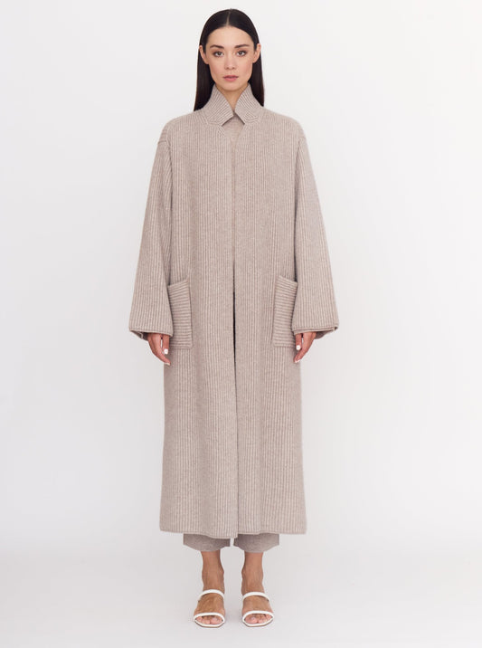 Front view of model wearing cool beige shade of ribbed cashmere knit long coat.