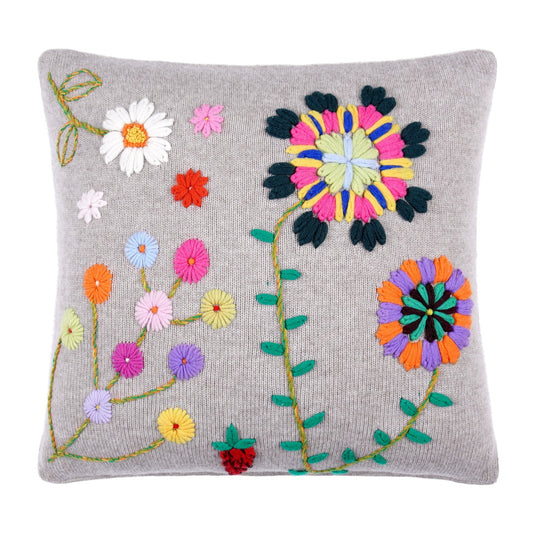 Beige cashmere knitted cushion with bright coloured floral hand embroidery.
