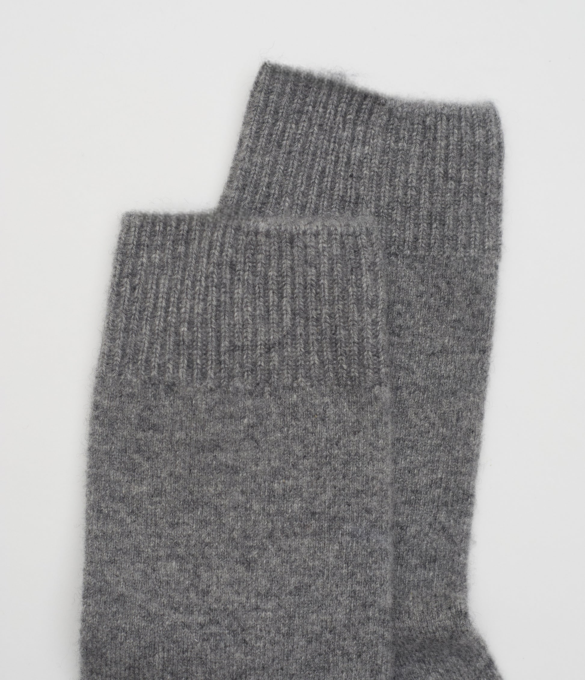 close up flat lay of grey ankle length Cashmere Socks with ribbed knit detail