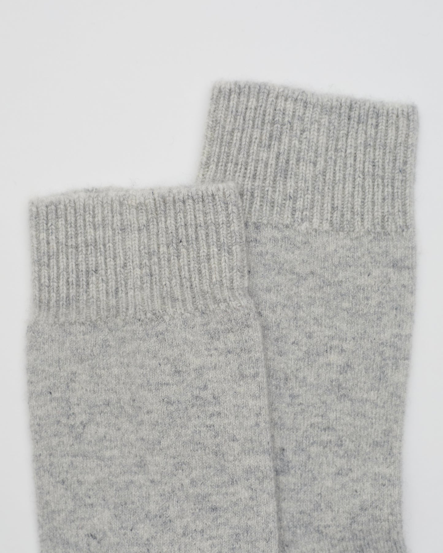 close up flat lay of light grey ankle length Cashmere Socks with ribbed knit detail