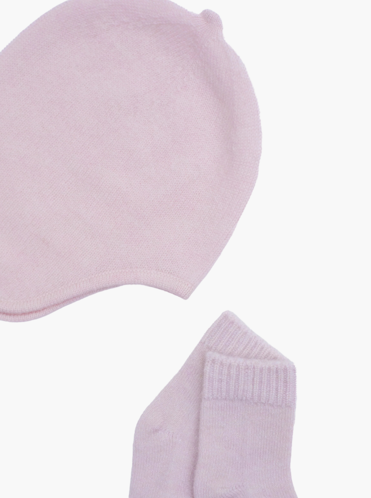 flat lay of the light pink cashmere baby hat and socks set