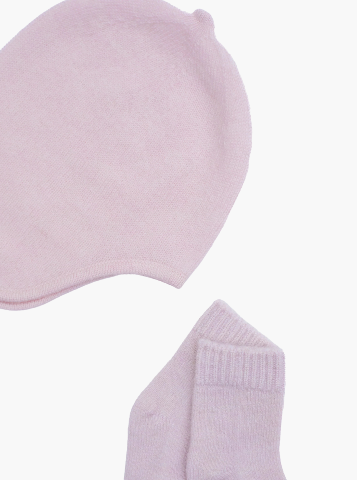 flat lay of the light pink cashmere baby hat and socks set