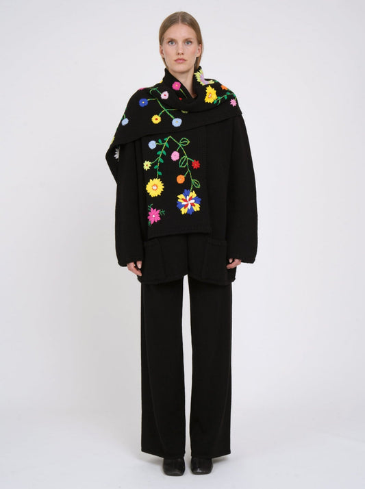Black cashmere hip length jacket with a detachable scarf which is hand embroidered with bright coloured flowers.