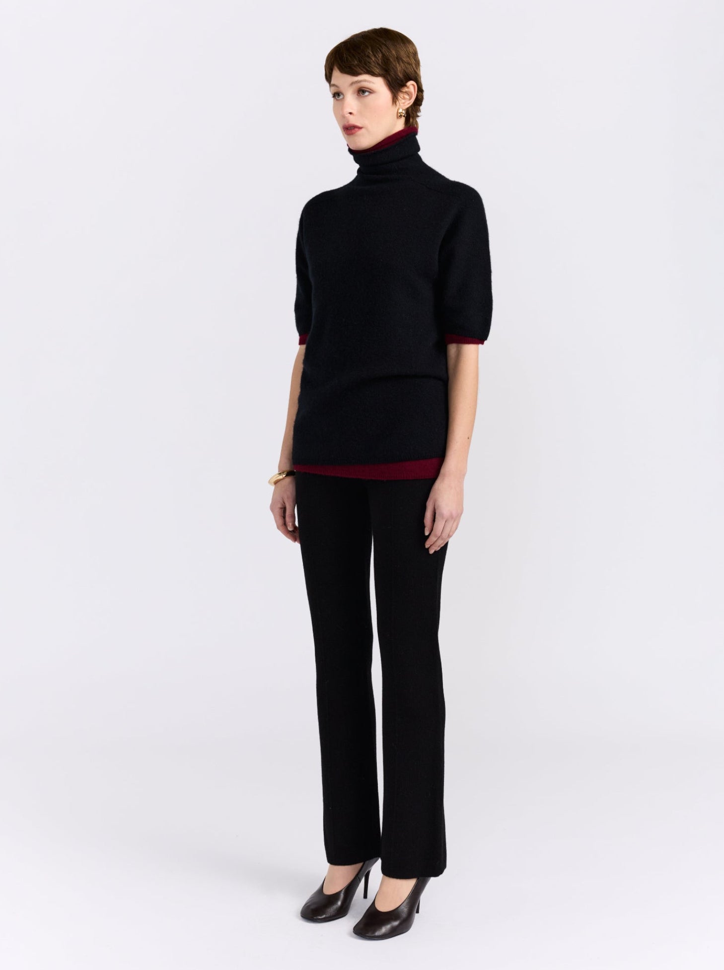 Black and burgundy cashmere sweater on model.
