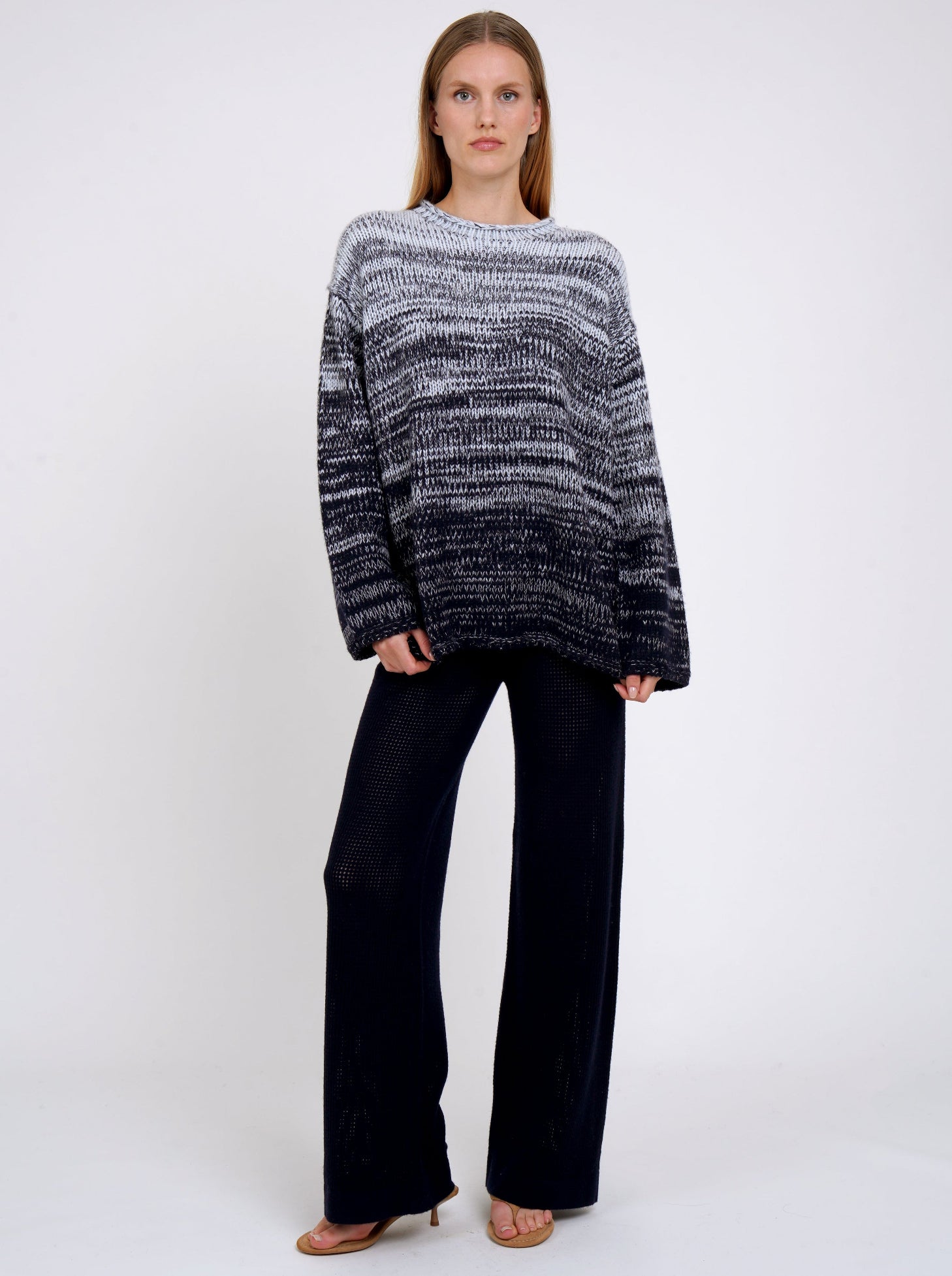 dark navy net knit pants worn with chunky knit sweater in pale blue mixed with dark navy.