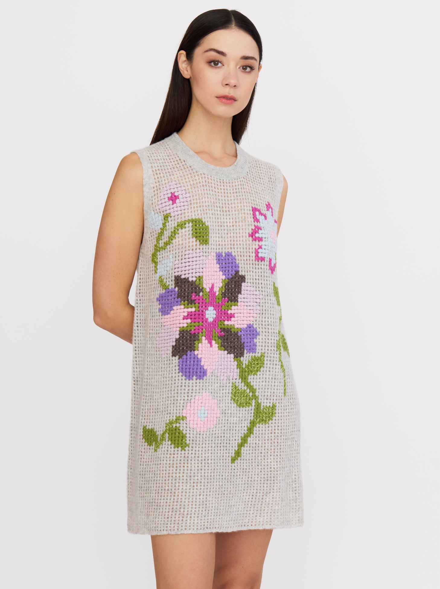 Grey cashmere dress with floral cross-stitch embroidery in vibrant colours, sleeveless and mini length.