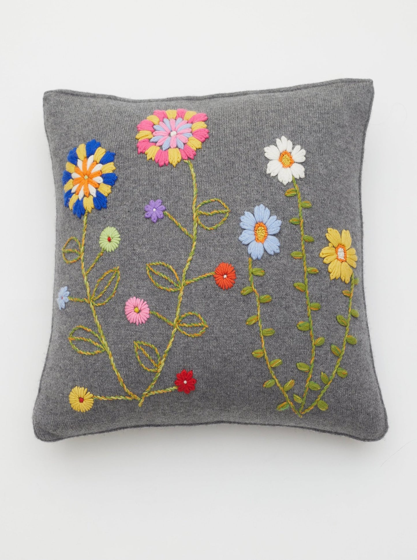 Square cushion with brightly coloured hand embroidered flowers in cashmere yarns.