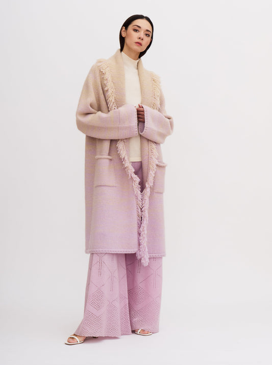 Light pink cashmere robe coat with fringe detailing, worn with matching pink knitted pants