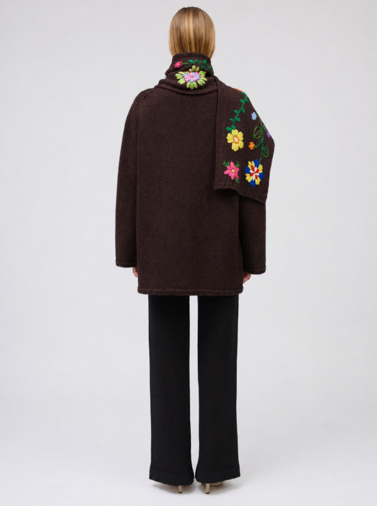 Back view model wearing mahogany brown cashmere hip-length jacket with brightly coloured hand-embroidered scarf.