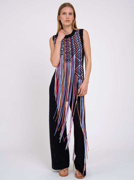 Navy light weight cashmere knit sleeveless tunic decorated with woven coloured fringes which fall to the ground worn with navy knit wide leg pants.