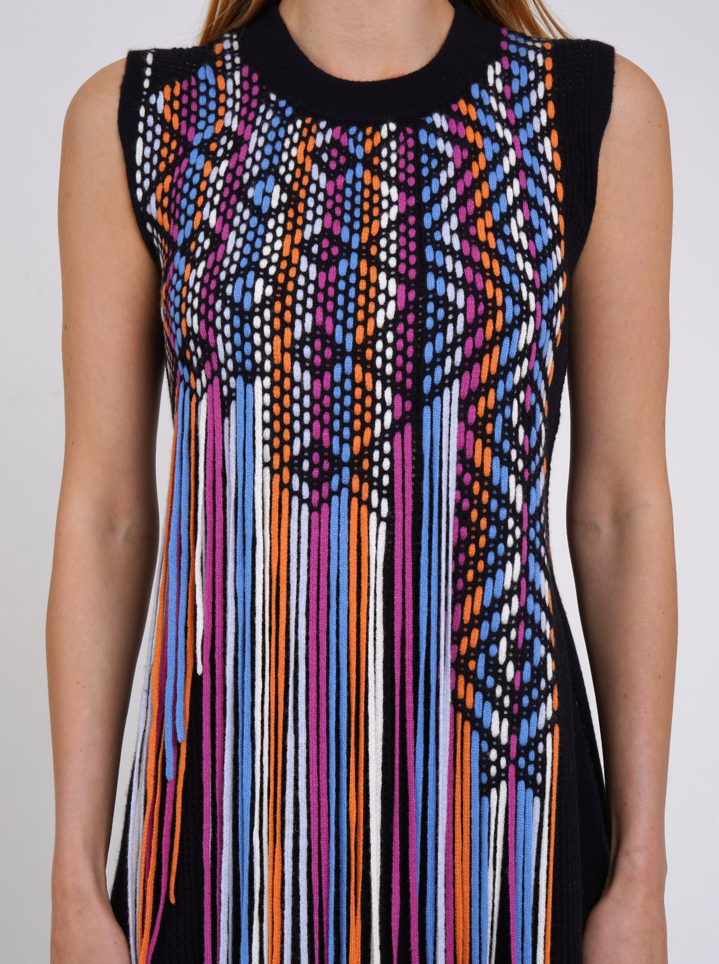 close up detail of coloured weave hand work on front body of navy sleeveless tunic top.