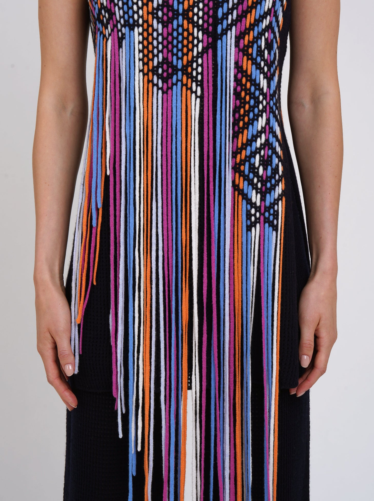 cropped detail navy light weight cashmere sleeveless tunic decorated with hand woven coloured long fringes.