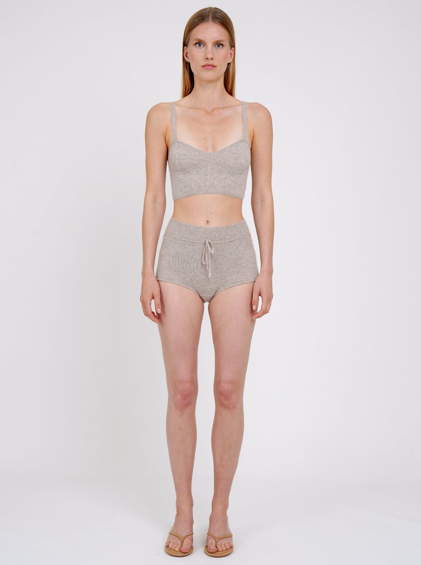 Front view model in beige knit cropped bra top and matching beige cashmere knit shorts with drawstring waist.