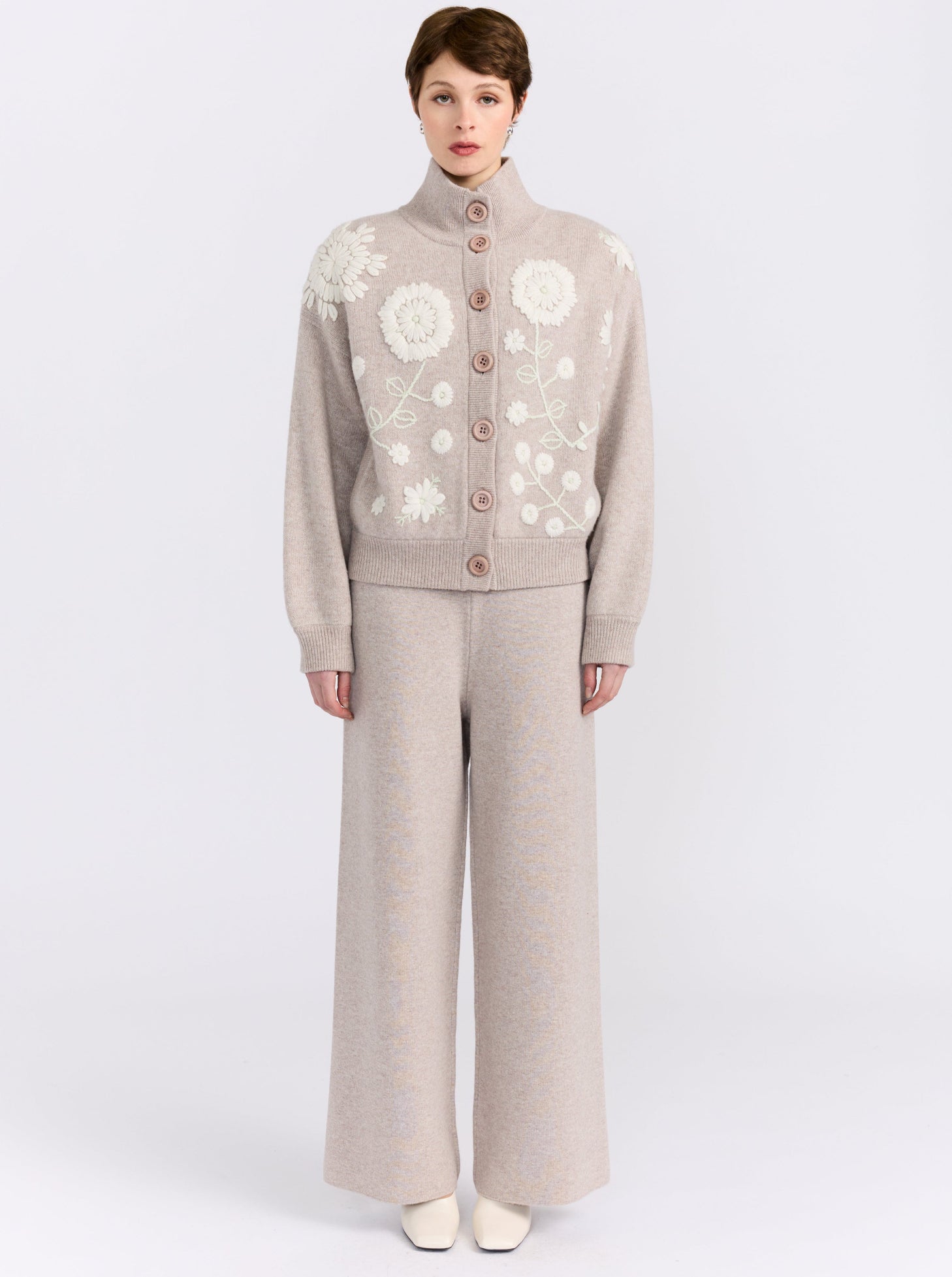 MANDKHAI new beige cashmere bomber jacket with hand-embroidered floral detailing, styled with matching wide-leg cashmere trousers.