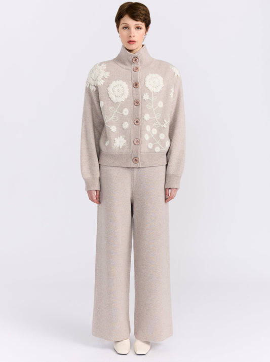 MANDKHAI new beige cashmere bomber jacket with hand-embroidered floral detailing, styled with matching wide-leg cashmere trousers.