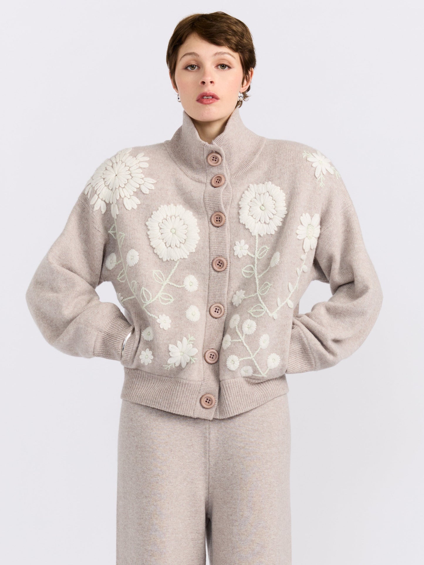 MANDKHAI new beige cashmere bomber jacket with hand-embroidered floral detailing, styled with matching wide-leg cashmere trousers.