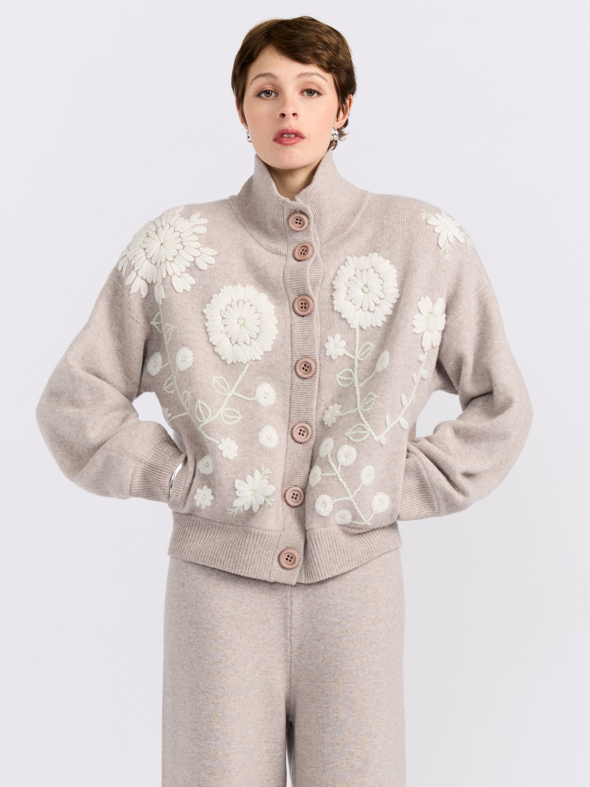MANDKHAI new beige cashmere bomber jacket with hand-embroidered floral detailing, styled with matching wide-leg cashmere trousers.