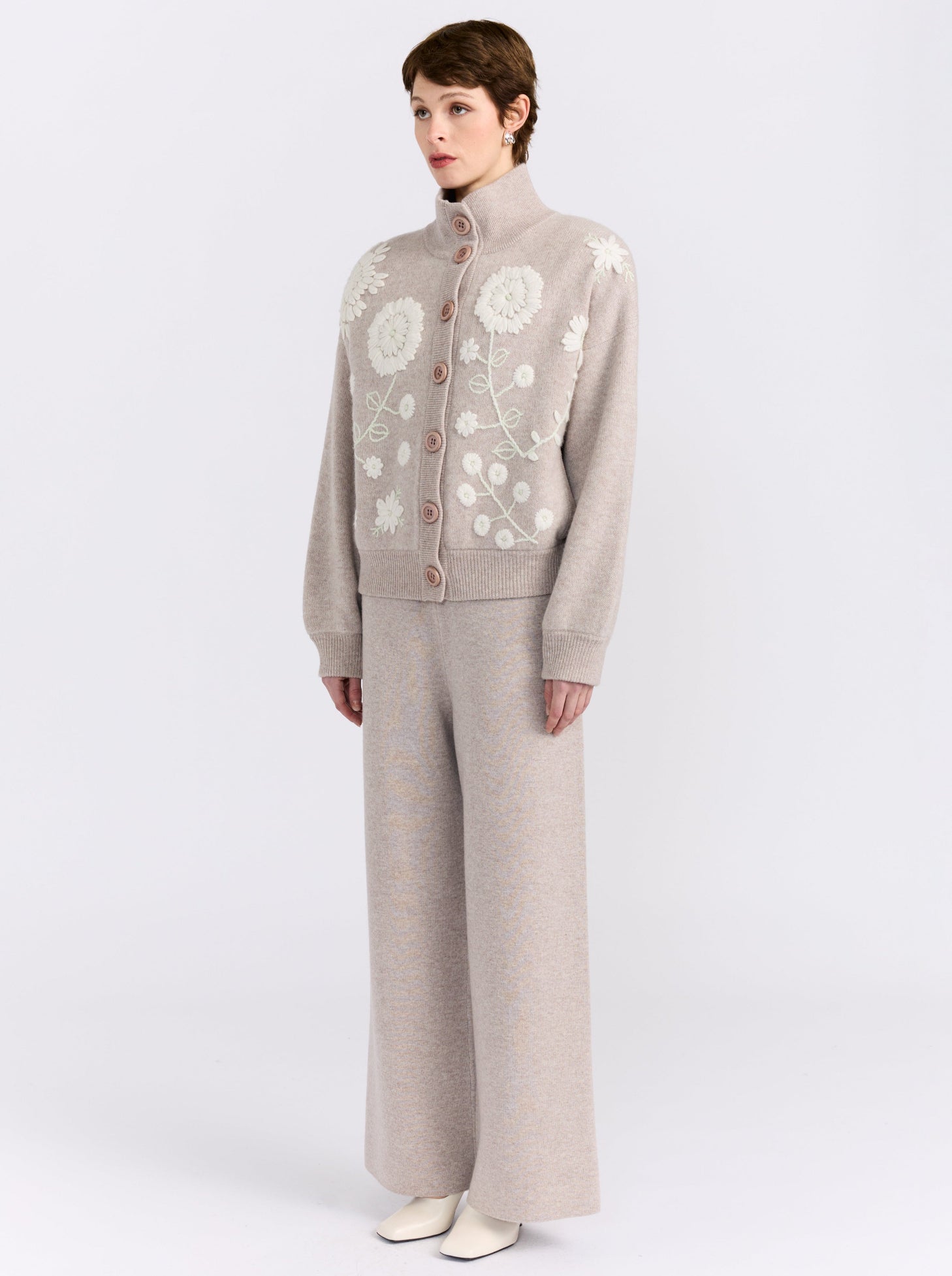 MANDKHAI new beige cashmere bomber jacket with hand-embroidered floral detailing, styled with matching wide-leg cashmere trousers.