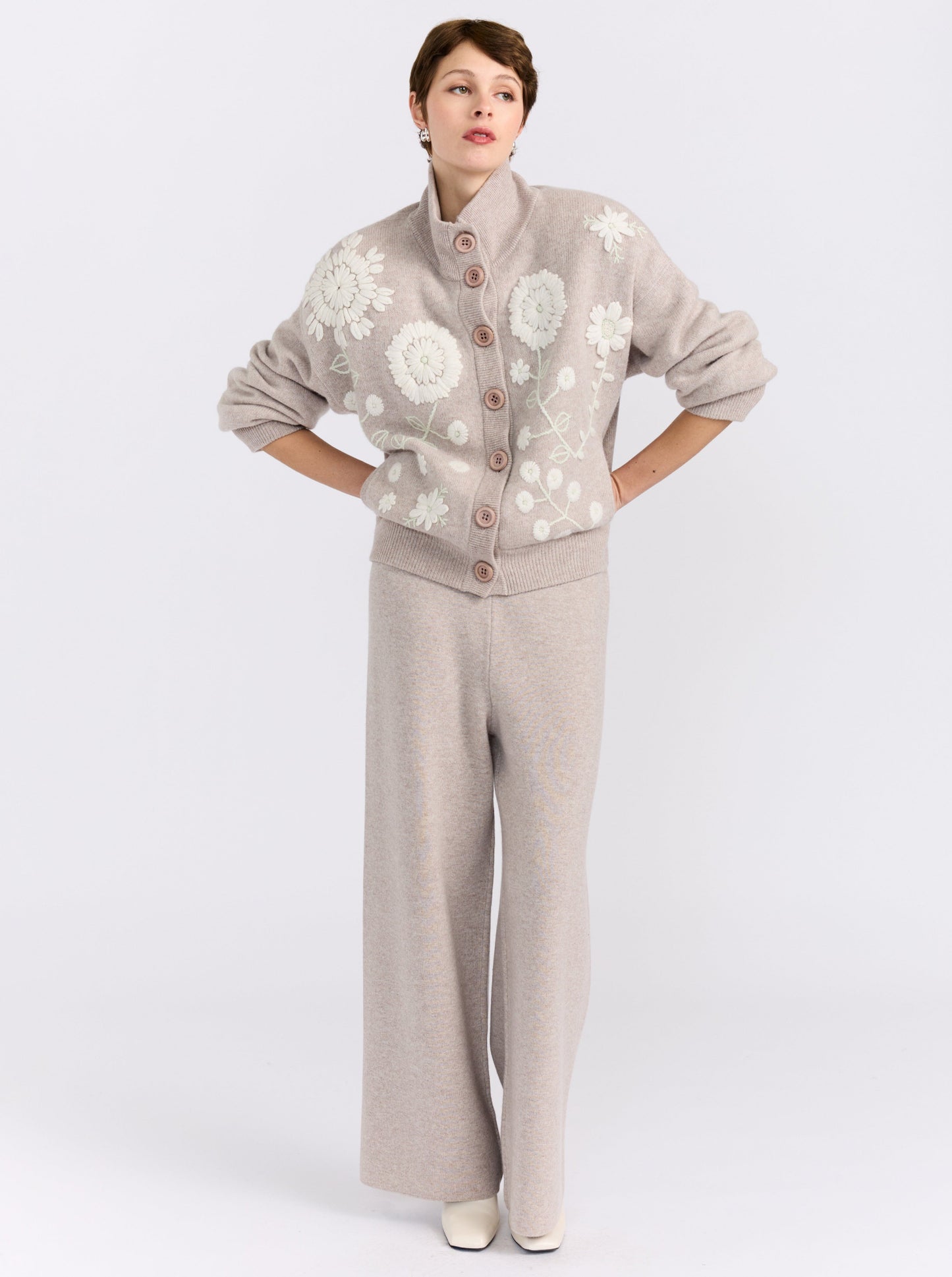MANDKHAI new beige cashmere bomber jacket with hand-embroidered floral detailing, styled with matching wide-leg cashmere trousers.