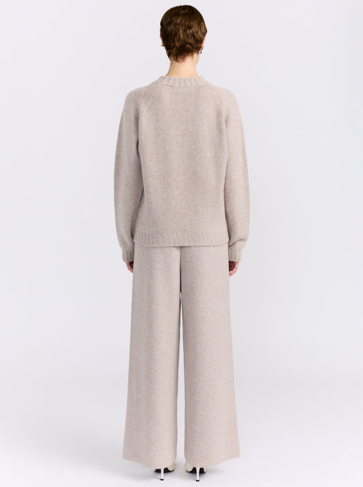 MANDKHAI new beige pure cashmere round neck sweater with raglan sleeves and a soft mink finish, styled with matching cashmere trousers.