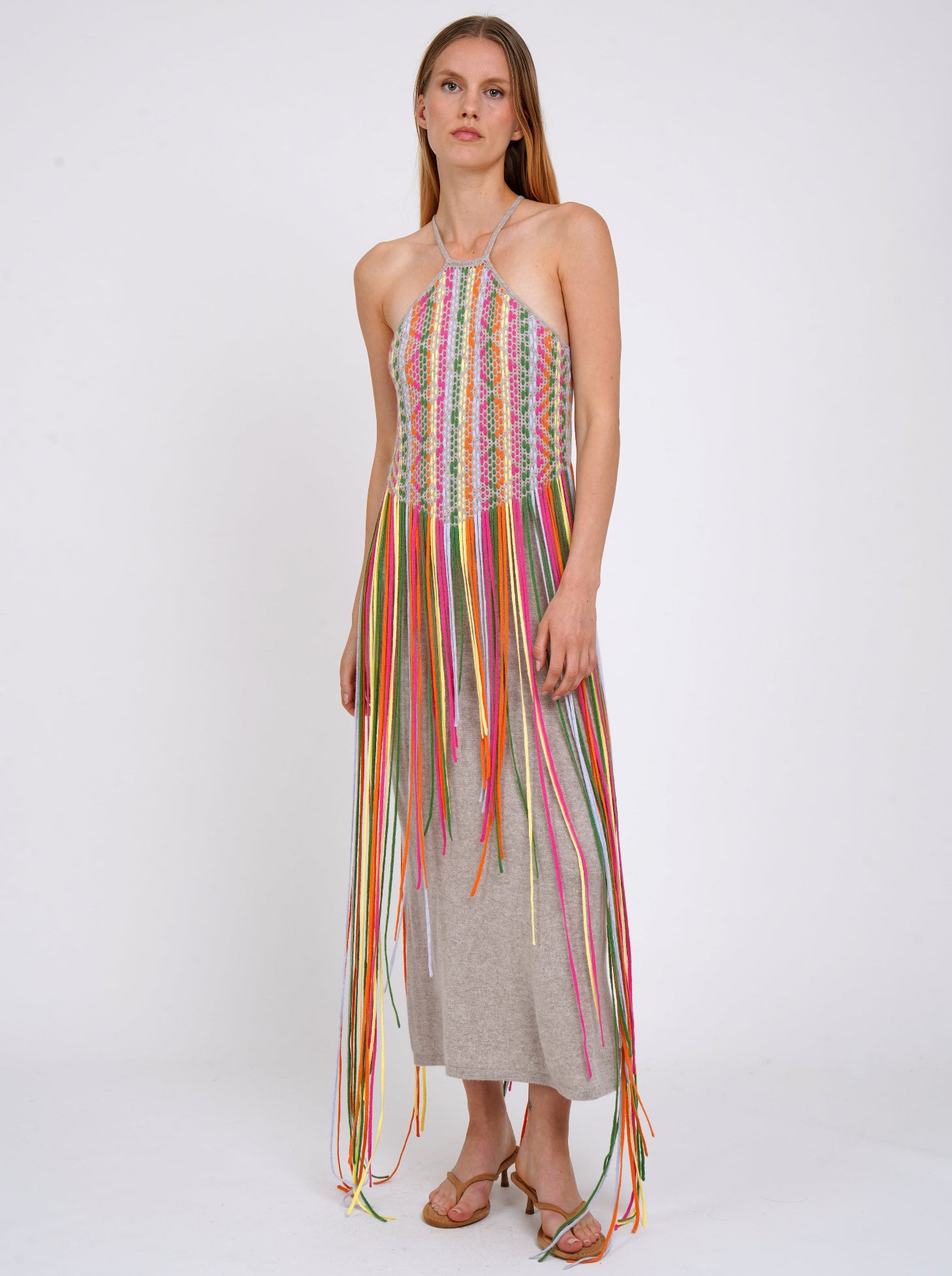 model wears summer weight cashmere knit dress with thin halterneck straps and decorated with coloured fringes