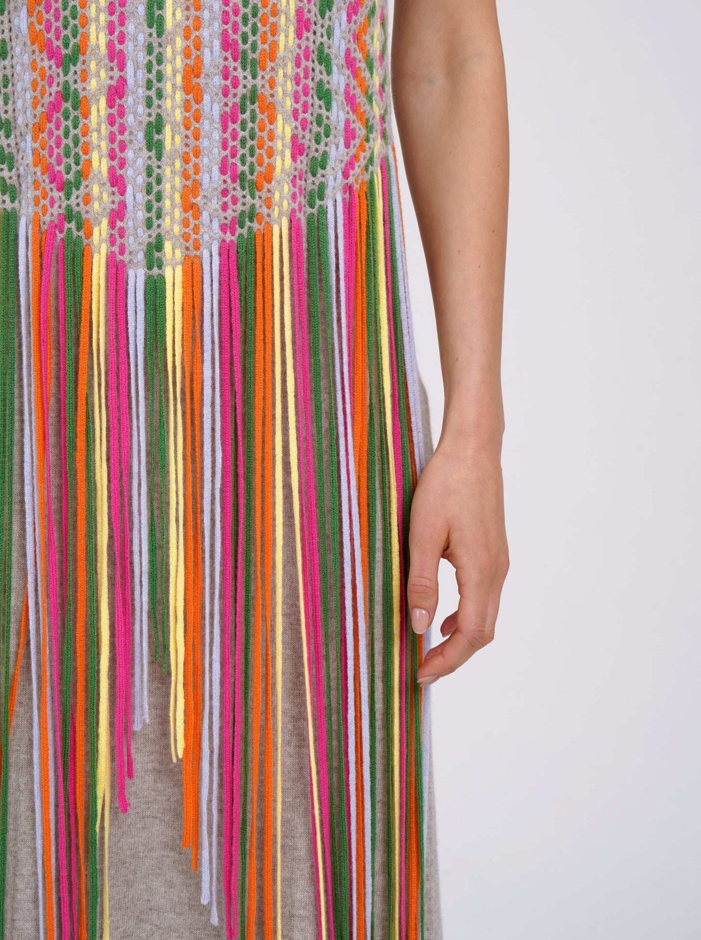 close up detail of multi colour fringe and weave detail on beige cashmere summer dress.
