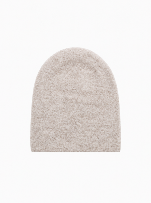 A light beige knit beanie hat with a soft, textured surface, shown flat against a solid white background.
