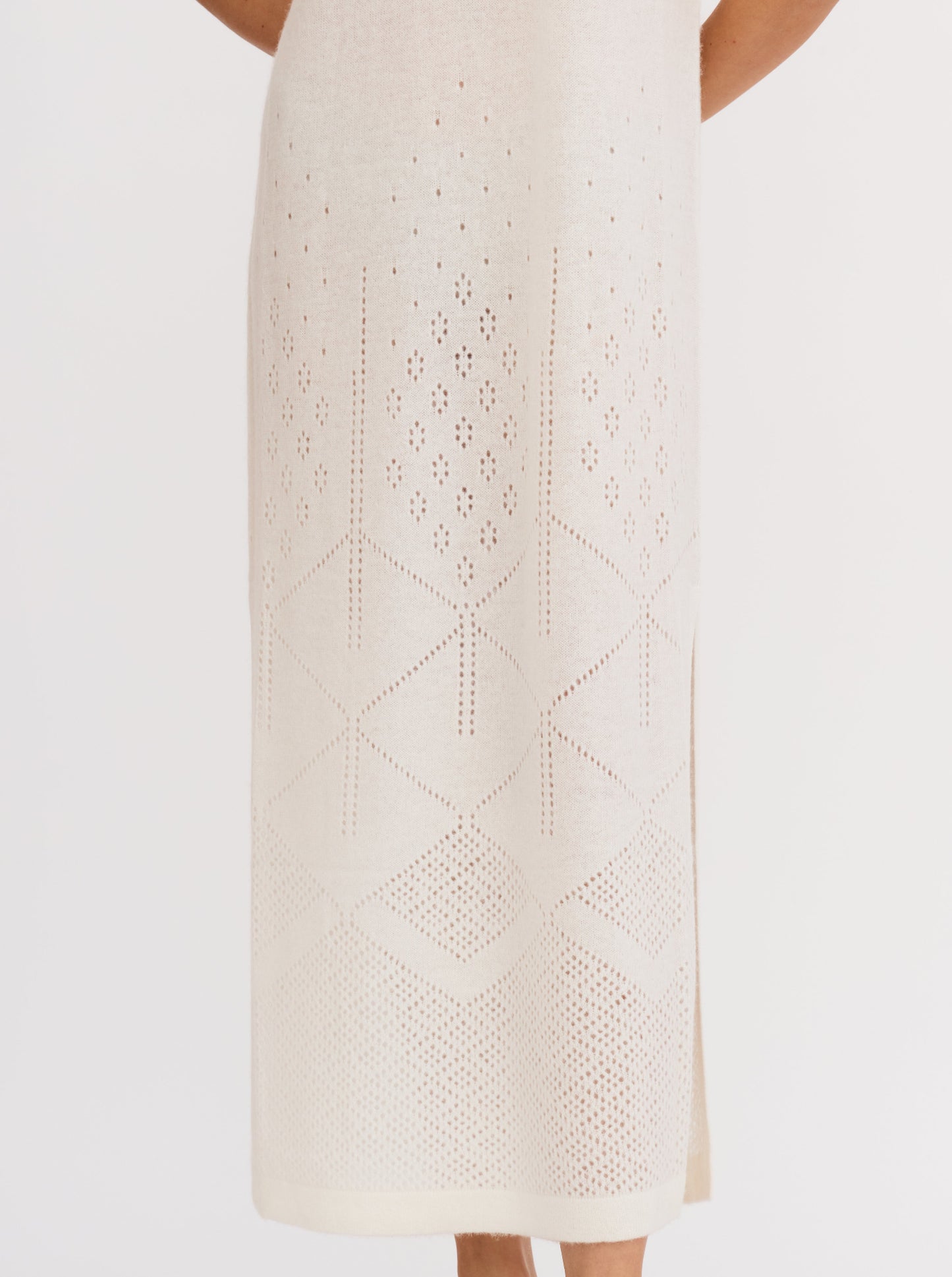 White sleeveless cashmere maxi dress with ajur knit design and geometric patterns at the hem