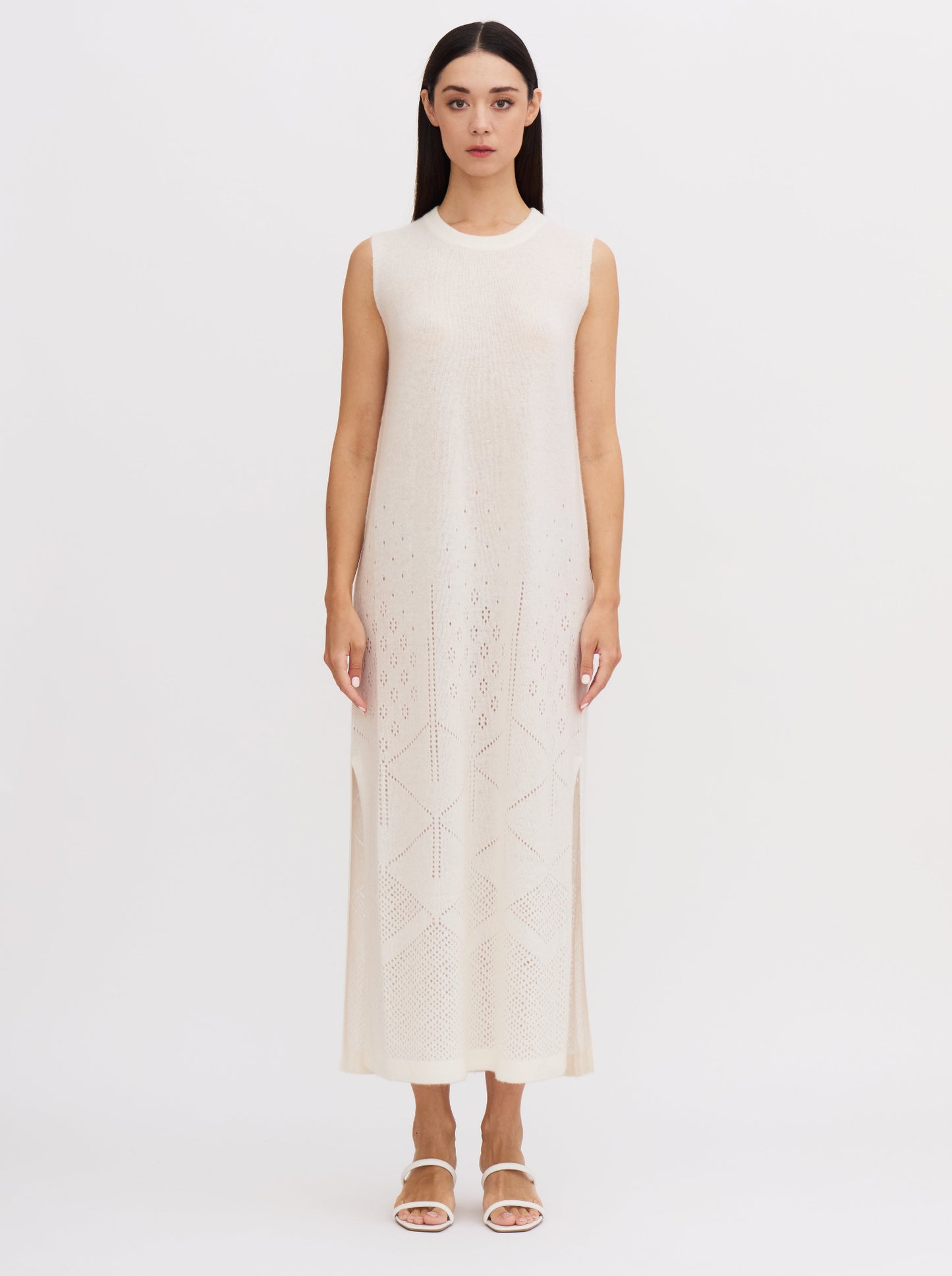 Front view of white sleeveless cashmere maxi dress with ajur knit design and geometric patterns at the hem.