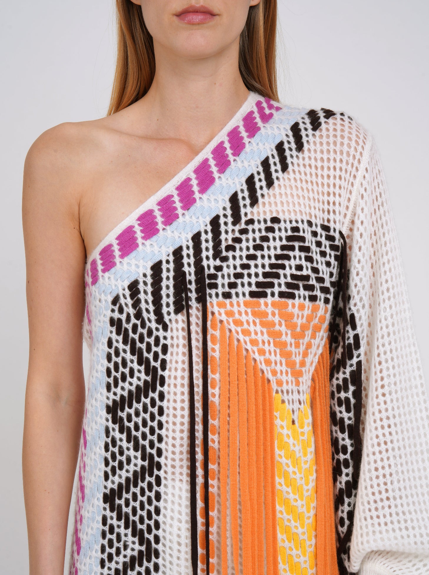 close-up detail front bodice white cashmere knit one shoulder shift dress with asymmetric neckline, decorated with coloured weave hand work. 