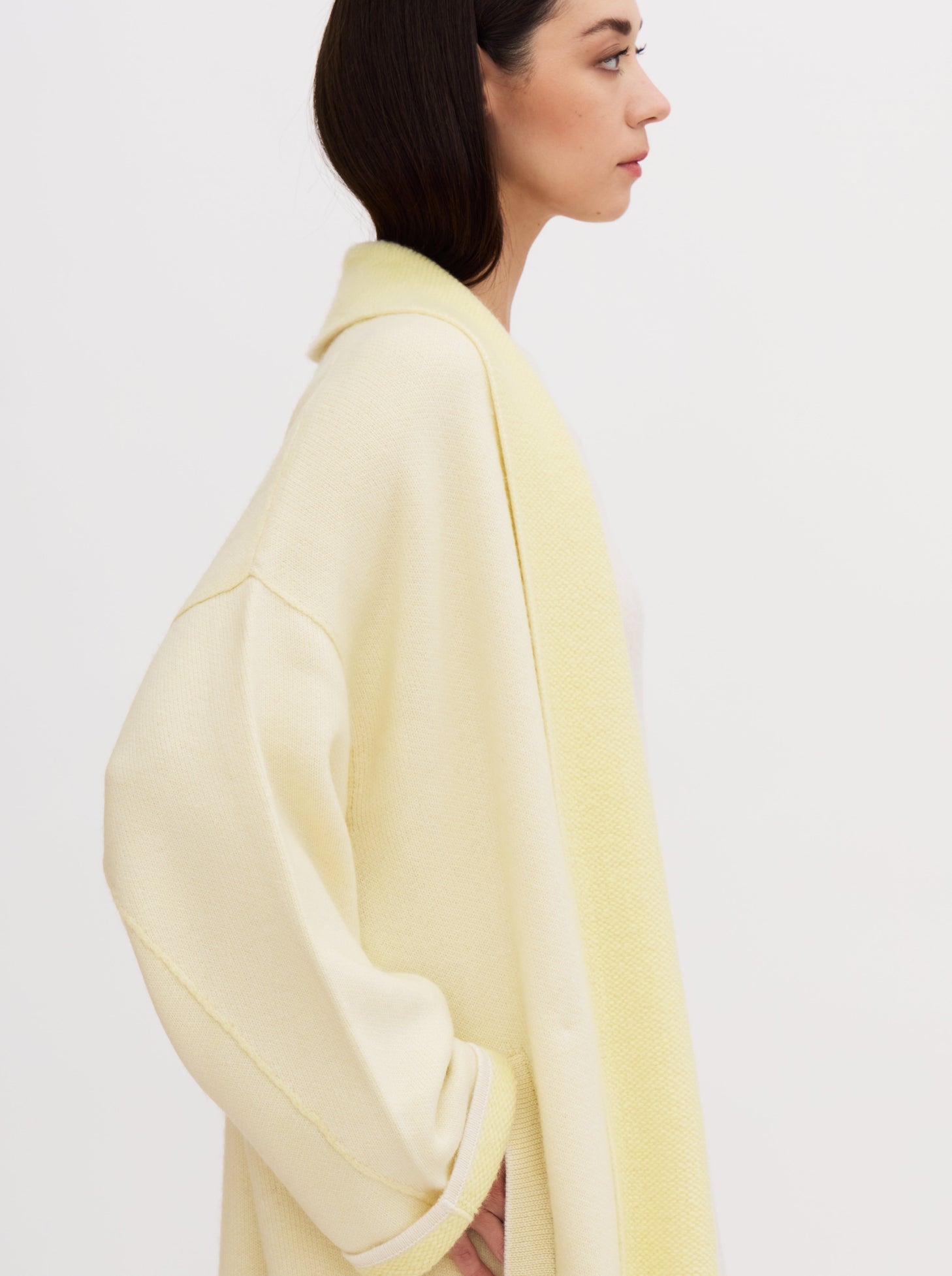 Long yellow balloon-shaped cashmere coat with a two-tone design and relaxed fit, featuring a shawl collar and wide sleeves.