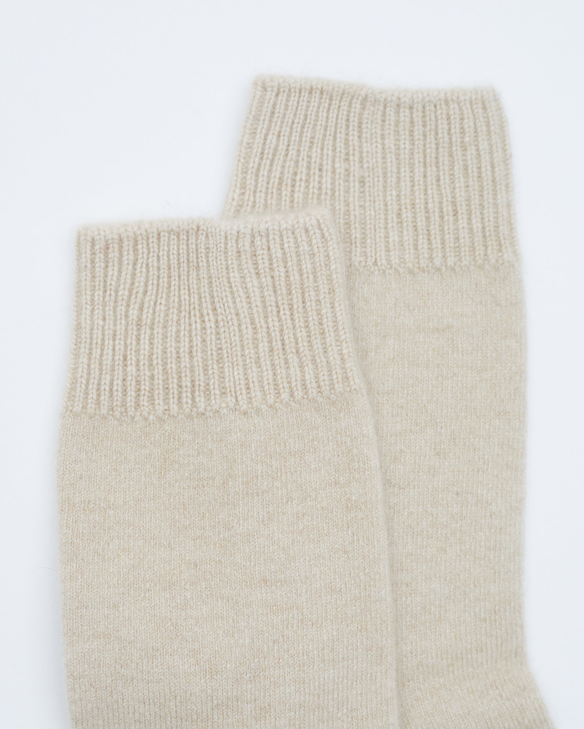 close up flat lay of Beige ankle length Cashmere Socks with ribbed knit detail 