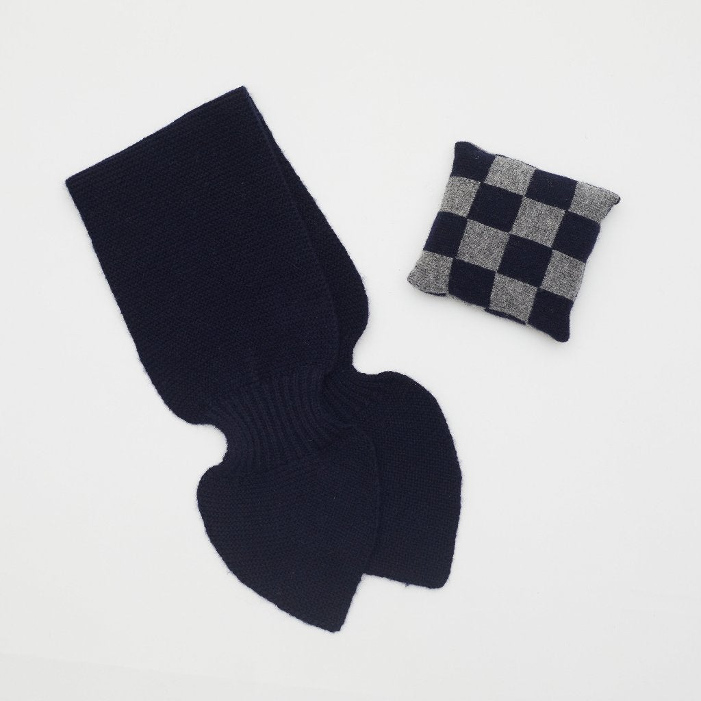 Flat lay of dark navy cashmere neck scarf and dark navy and grey checked mini lavender cushion set 