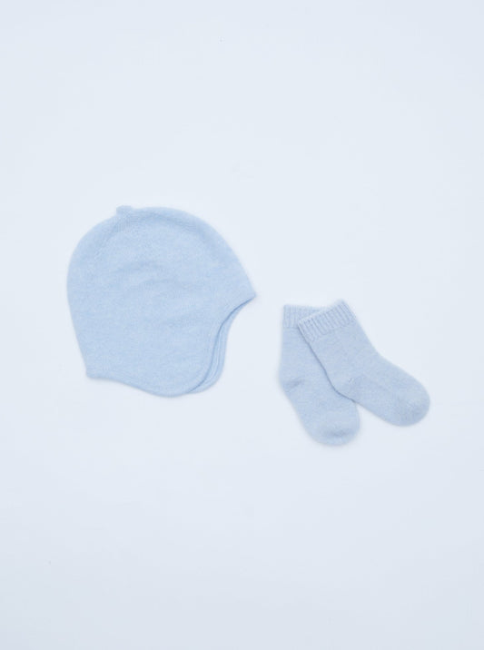 flat lay of the light blue cashmere baby hat and socks set