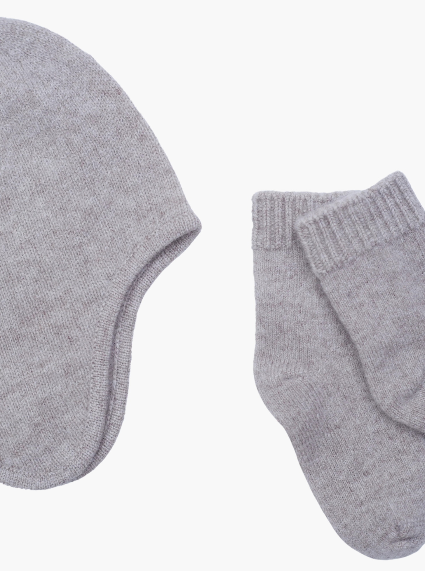 close up of the light brown cashmere baby hat and socks set