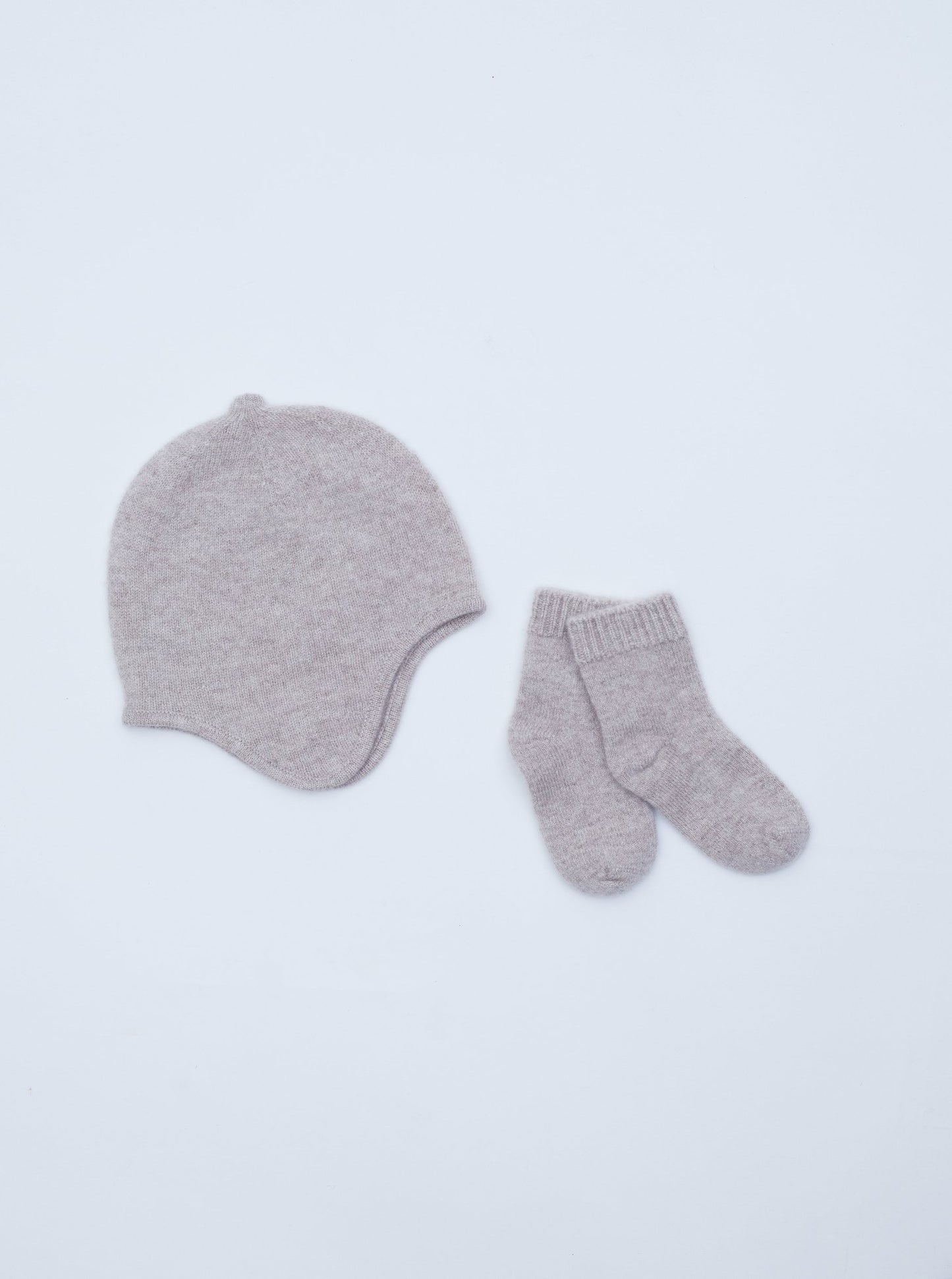 flat lay of the light brown cashmere baby hat and socks set