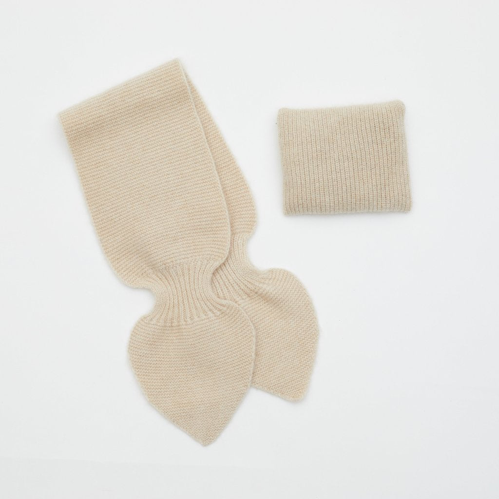 Flat lay of light brown cashmere neck scarf and light brown mini lavender cushion set 