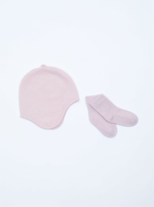 flat lay of the light pink cashmere baby hat and socks set