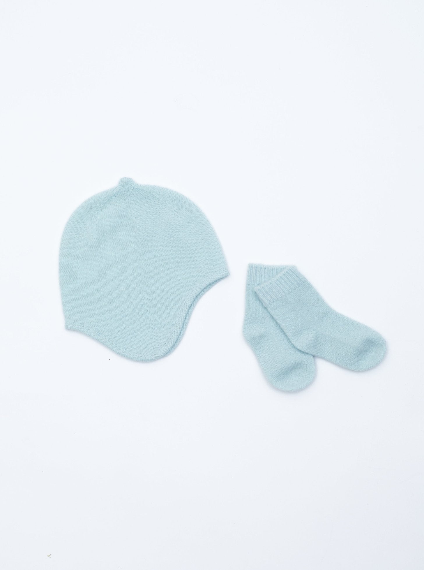 flat lay of the mint green cashmere baby hat and socks set