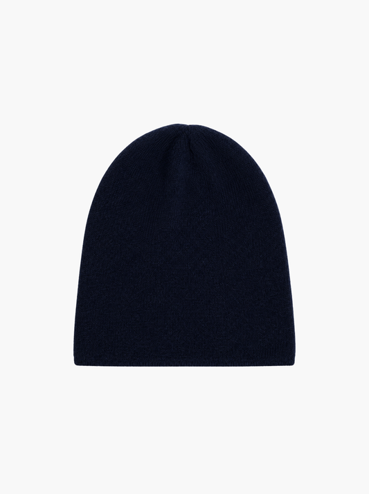 A dark navy blue knit beanie hat, photographed flat against a solid white background.