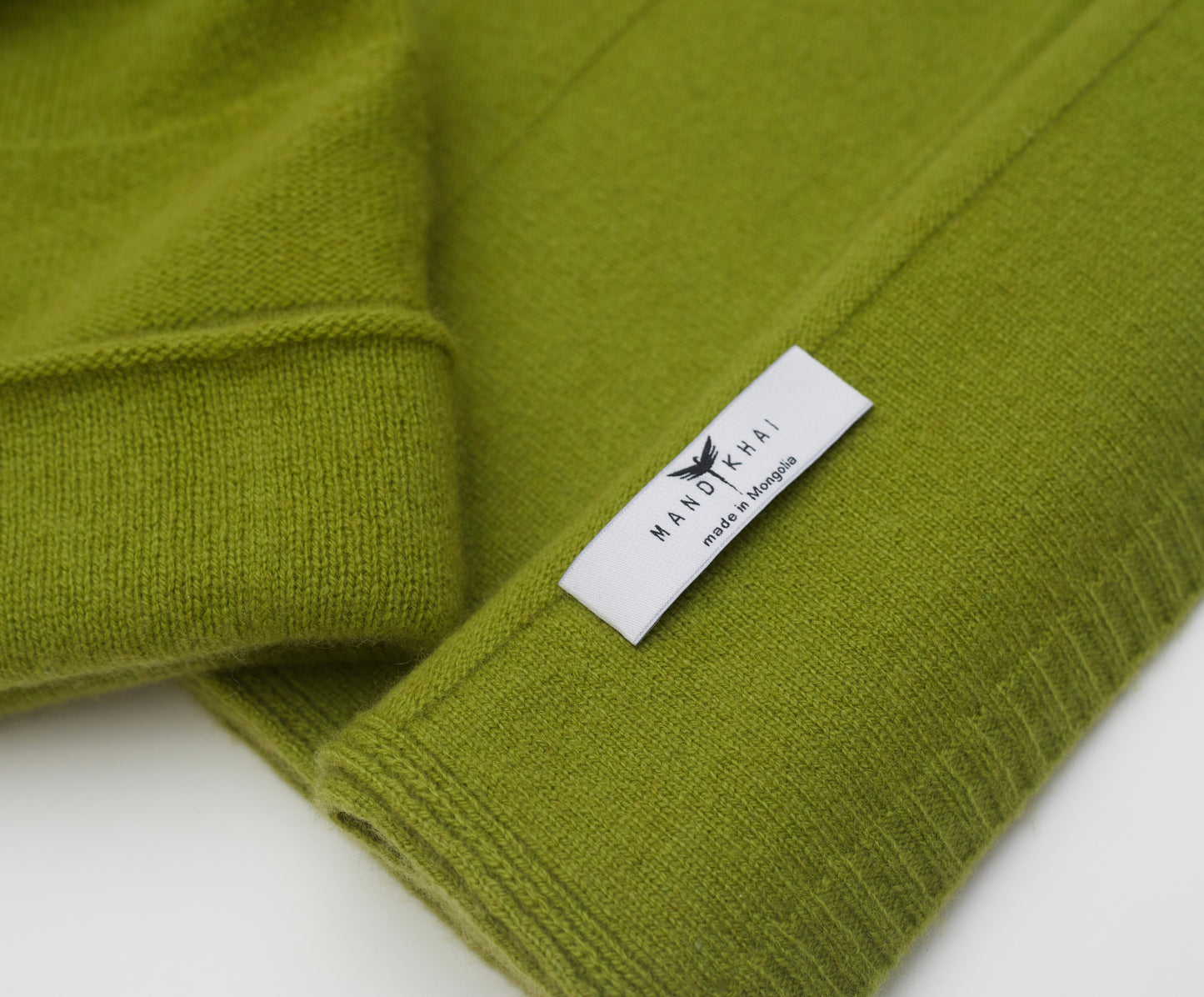 close up flat lay of the olive green banded stripe Cashmere Scarf and Beanie Set in a two way knit pattern