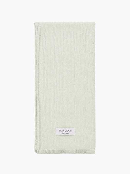 A pistachio green folded pure cashmere scarf.