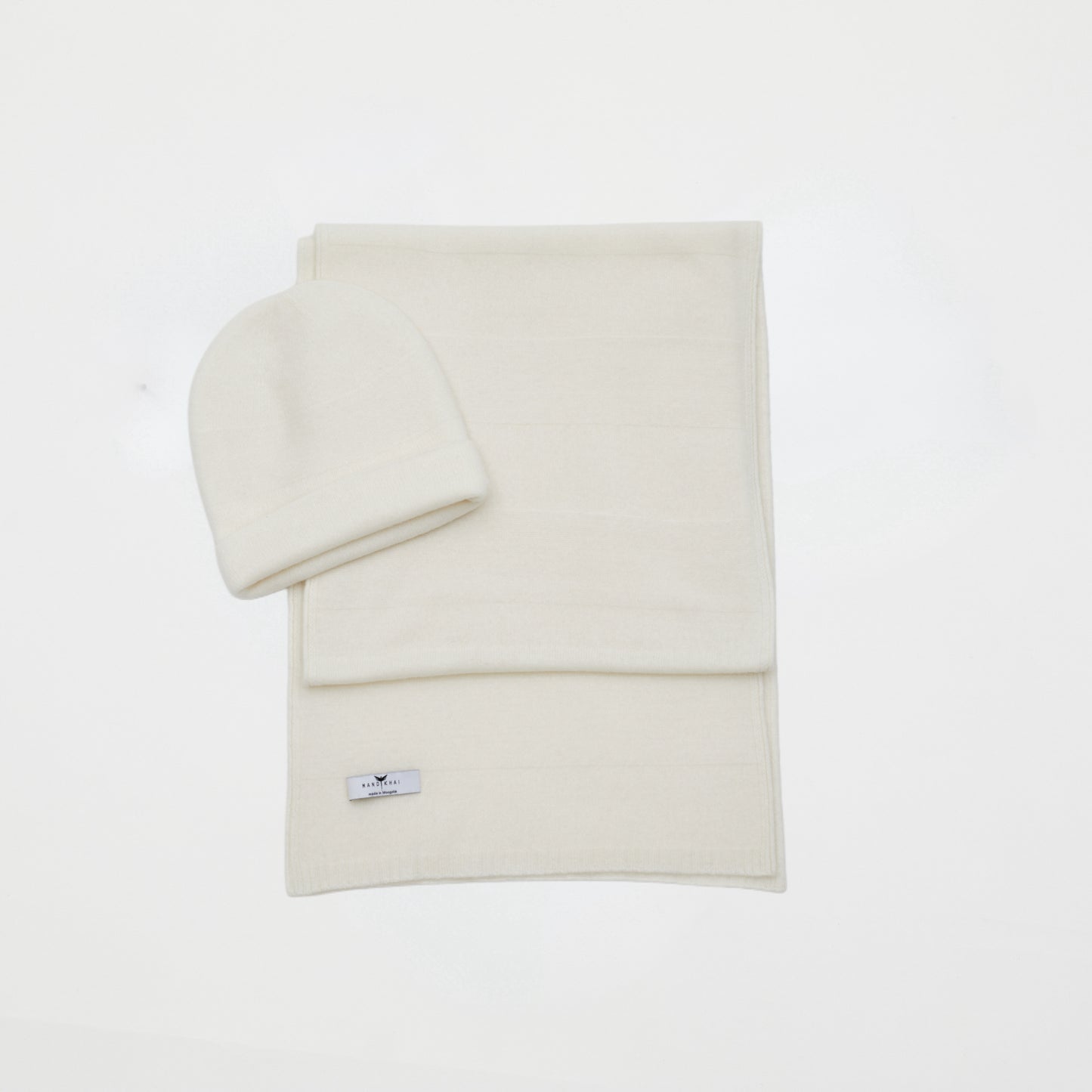 front flat lay of the white banded stripe Cashmere Scarf and Beanie Set in a two way knit pattern 